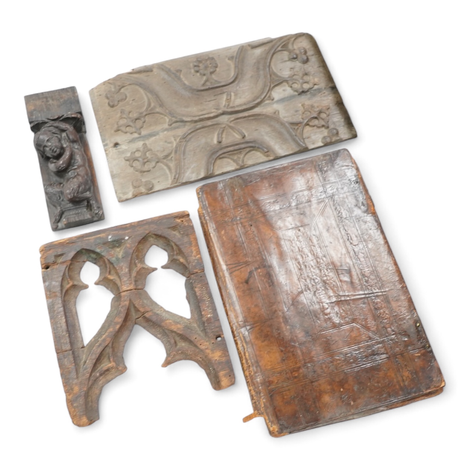 A 19th century leather binding for a book, 35cm high x 33.5cm wide, two carved gothic panels and a carved figure